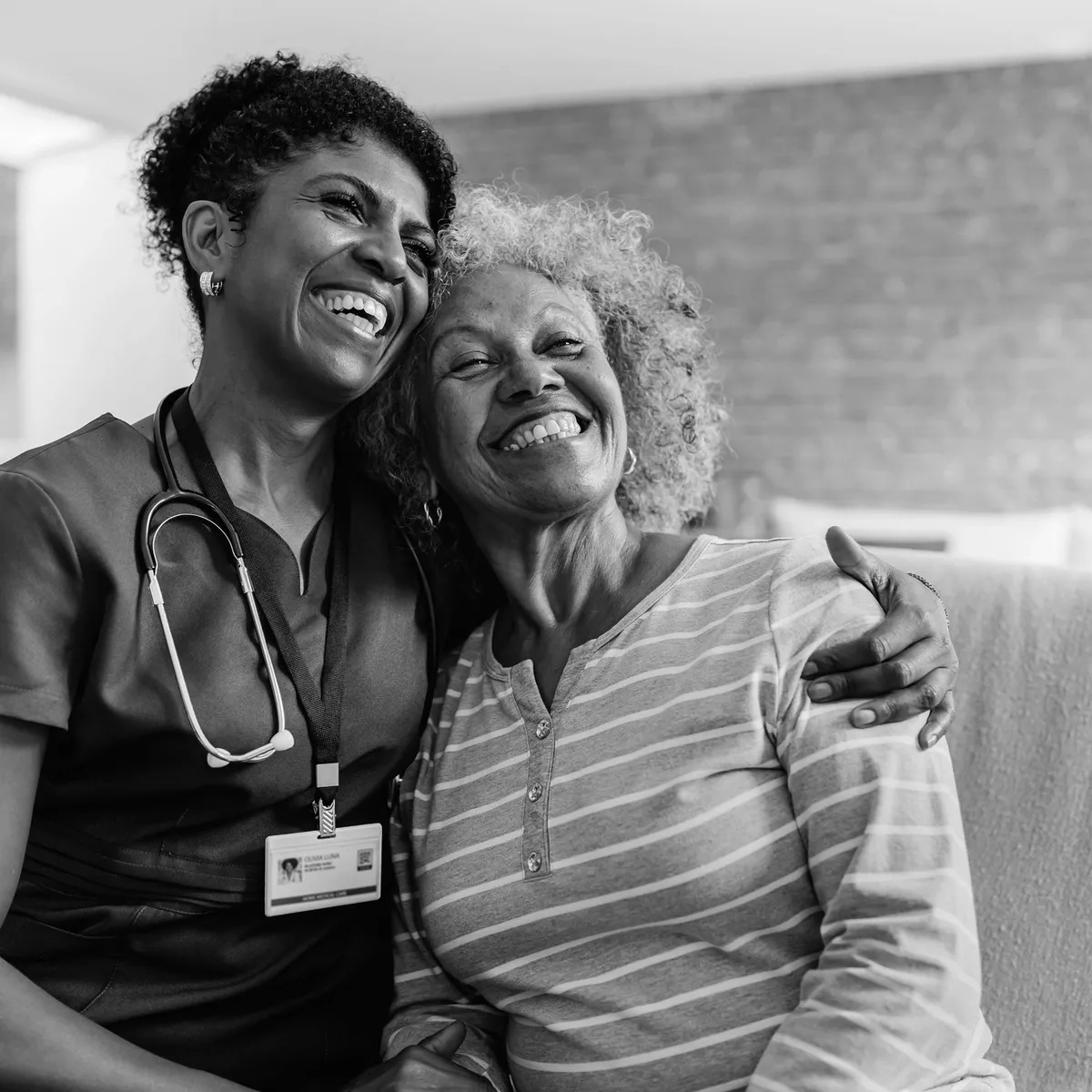 Nurse embracing smiling senior